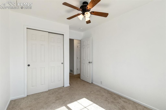 8463 Shadow Run Ln, Fountain, CO 80817 - unfurnished bedroom with light carpet, a closet, baseboards, and ceiling fan