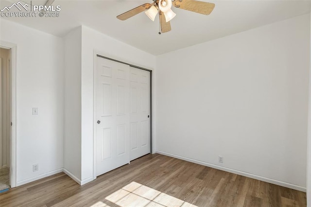 8463 Shadow Run Ln, Fountain, CO 80817 - unfurnished bedroom featuring wood finished floors, a closet, baseboards, and a ceiling fan