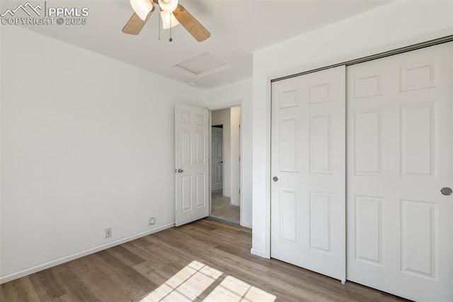 8463 Shadow Run Ln, Fountain, CO 80817 - unfurnished bedroom with attic access, light wood-style floors, a closet, baseboards, and a ceiling fan