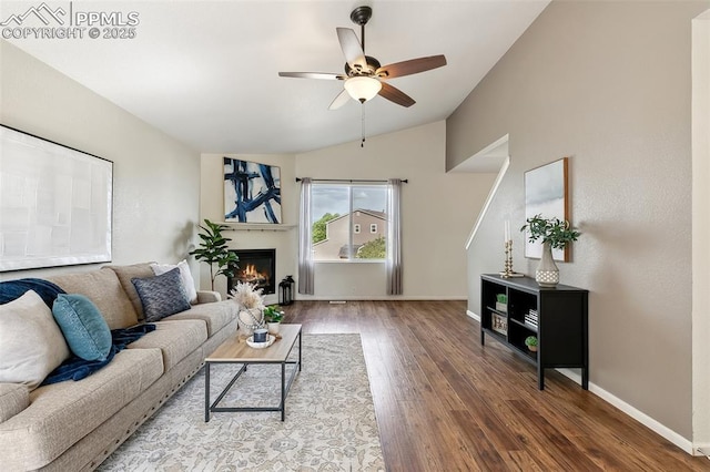 8463 Shadow Run Ln, Fountain, CO 80817 - living area with lofted ceiling, wood finished floors, a ceiling fan, baseboards, and a warm lit fireplace