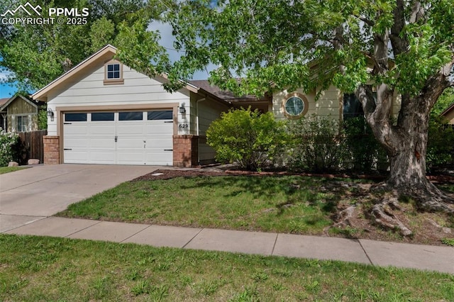 629 Golden Eagle Dr, Colorado Springs, CO 80916 - view of front facade with brick siding, concrete driveway, a garage, and a front yard