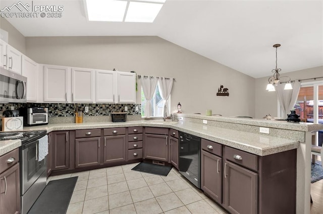 629 Golden Eagle Dr, Colorado Springs, CO 80916 - kitchen featuring stainless steel appliances, a peninsula, light countertops, plenty of natural light, and lofted ceiling