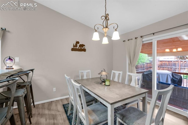 629 Golden Eagle Dr, Colorado Springs, CO 80916 - dining area with a chandelier, light wood-style flooring, and baseboards