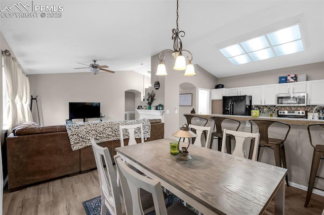 629 Golden Eagle Dr, Colorado Springs, CO 80916 - dining area featuring arched walkways, vaulted ceiling, light wood-type flooring, and a ceiling fan