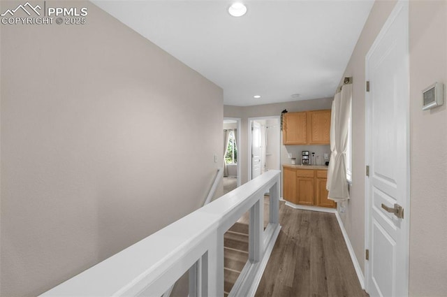 629 Golden Eagle Dr, Colorado Springs, CO 80916 - hallway with dark wood-type flooring, recessed lighting, and baseboards