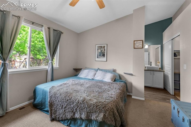 629 Golden Eagle Dr, Colorado Springs, CO 80916 - carpeted bedroom featuring lofted ceiling, baseboards, ensuite bath, ceiling fan, and a sink