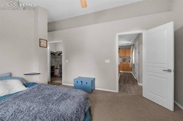 629 Golden Eagle Dr, Colorado Springs, CO 80916 - bedroom with carpet flooring, a walk in closet, and baseboards