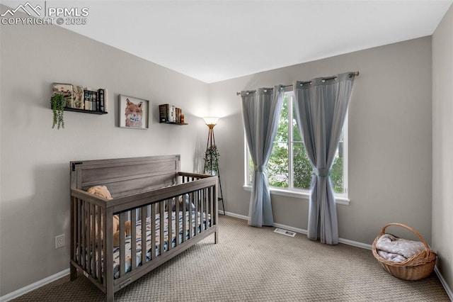629 Golden Eagle Dr, Colorado Springs, CO 80916 - carpeted bedroom with baseboards and a nursery area