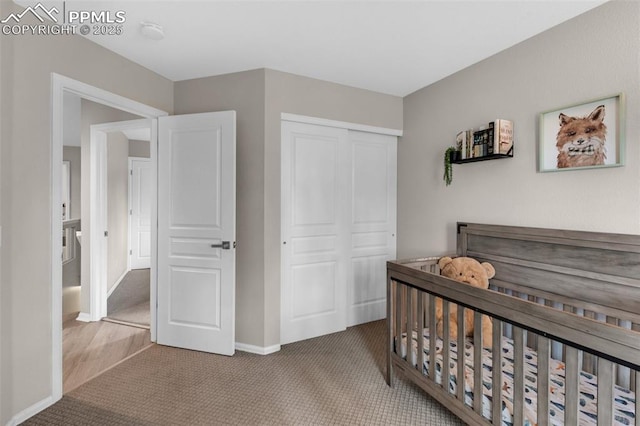 629 Golden Eagle Dr, Colorado Springs, CO 80916 - carpeted bedroom with a closet, baseboards, and a crib