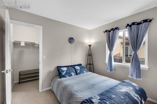 629 Golden Eagle Dr, Colorado Springs, CO 80916 - bedroom with carpet flooring, baseboards, and a walk in closet