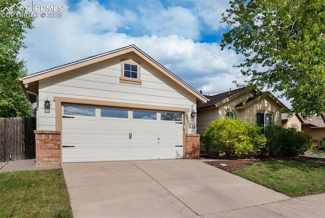 629 Golden Eagle Dr, Colorado Springs, CO 80916 - ranch-style home featuring fence, driveway, and brick siding