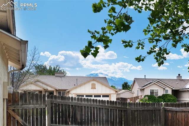 629 Golden Eagle Dr, Colorado Springs, CO 80916 - rear view of house with board and batten siding, fence, and an attached garage