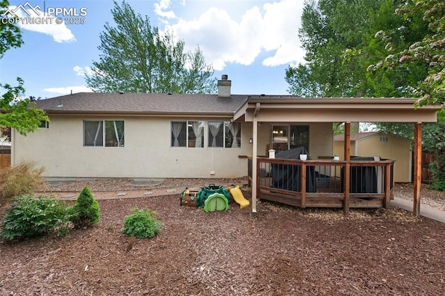 629 Golden Eagle Dr, Colorado Springs, CO 80916 - view of front of property featuring a shed, an outbuilding, a chimney, stucco siding, and a wooden deck