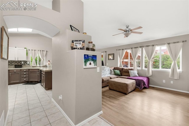 629 Golden Eagle Dr, Colorado Springs, CO 80916 - living room featuring ceiling fan, light wood-type flooring, baseboards, and a high ceiling