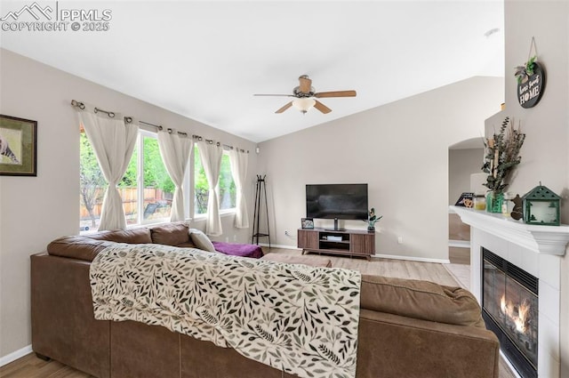 629 Golden Eagle Dr, Colorado Springs, CO 80916 - living area featuring wood finished floors, a fireplace, a ceiling fan, baseboards, and lofted ceiling