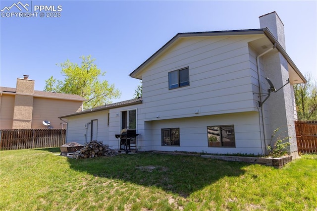 7630 Pebble Path Pl, Colorado Springs, CO 80920 - rear view of property with a chimney and a fire pit