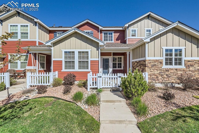 8883 White Prairie Vw, Colorado Springs, CO 80924 - view of front of house with board and batten siding, stone siding, and a shingled roof