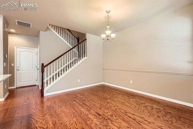 8883 White Prairie Vw, Colorado Springs, CO 80924 - stairway with a chandelier, wood finished floors, and baseboards