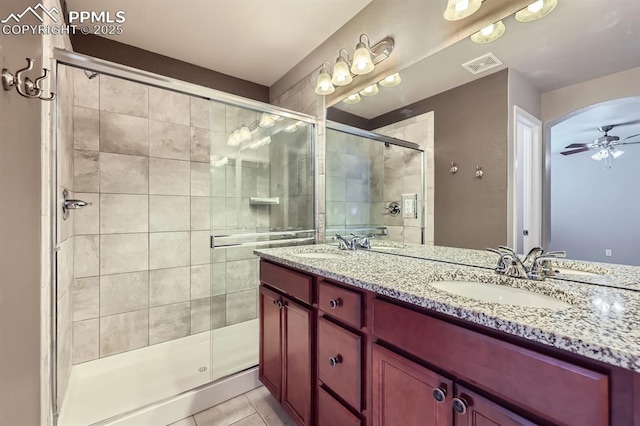 8883 White Prairie Vw, Colorado Springs, CO 80924 - full bath with a shower stall, ceiling fan, double vanity, and tile patterned floors