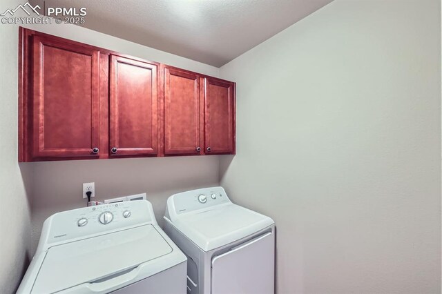 8883 White Prairie Vw, Colorado Springs, CO 80924 - clothes washing area featuring cabinet space and washing machine and dryer
