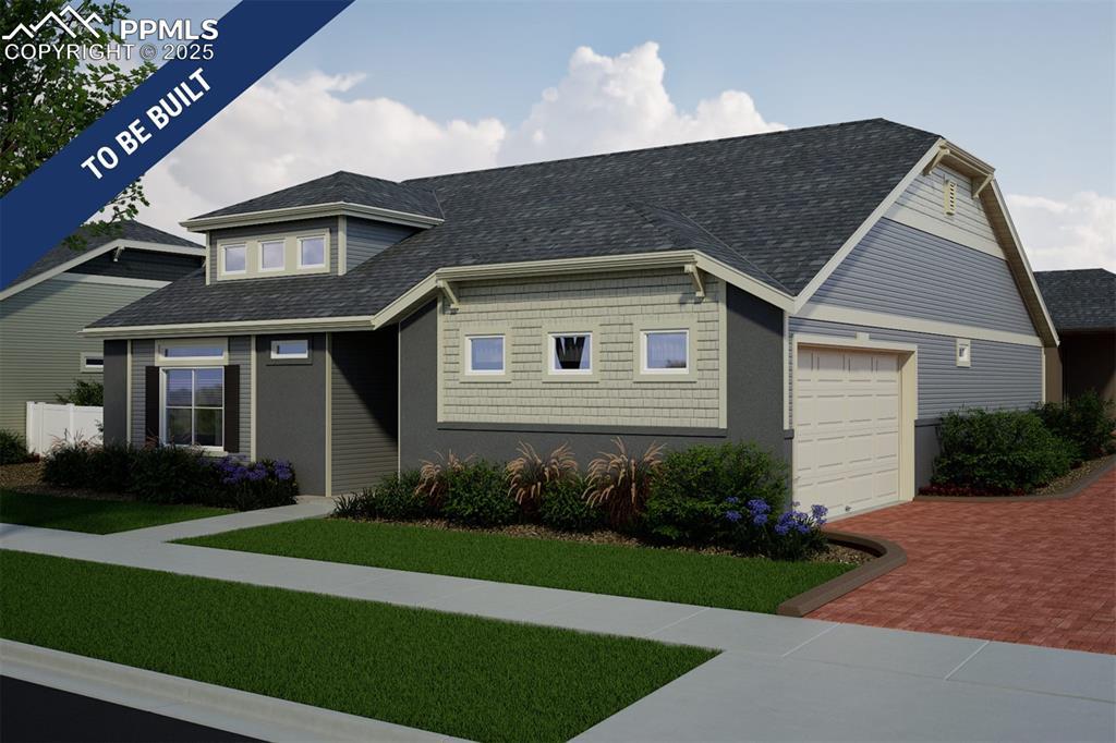 5849 Mireland Vw, Colorado Springs, CO 80927 - view of front facade featuring a garage, decorative driveway, a front yard, and a shingled roof