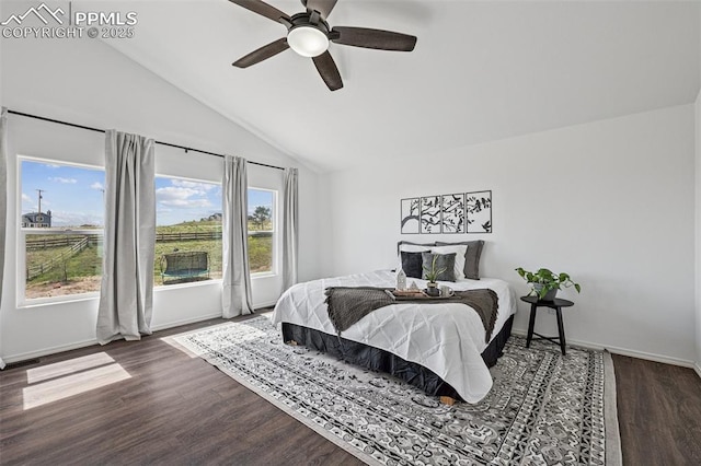 bedroom with lofted ceiling, baseboards, dark wood finished floors, and a ceiling fan