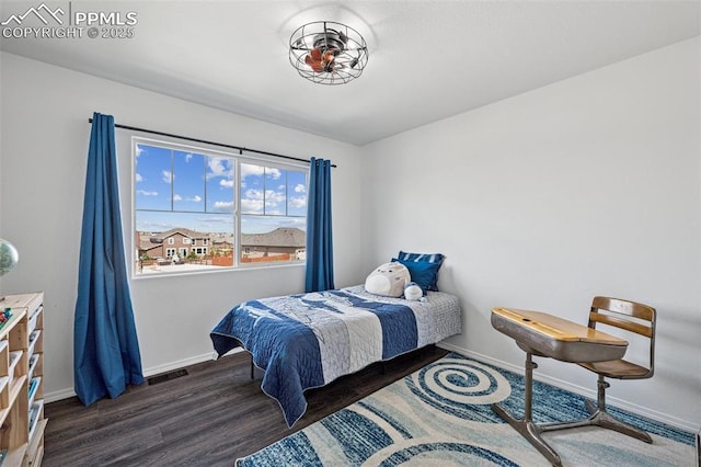 bedroom with baseboards and wood finished floors
