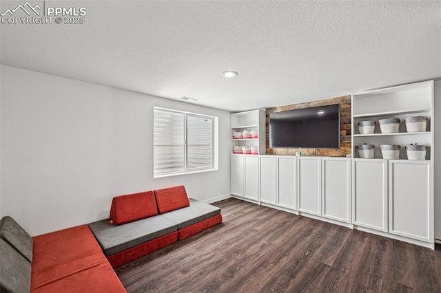 unfurnished living room featuring wood finished floors, a textured ceiling, recessed lighting, and baseboards