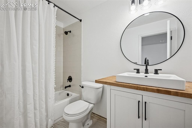 bathroom featuring toilet, shower / tub combo, and vanity