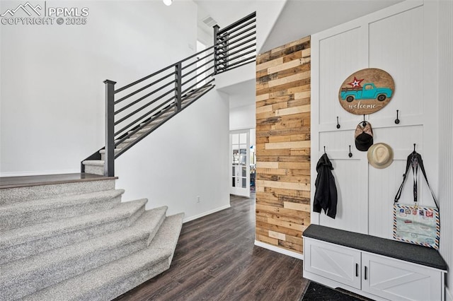 staircase featuring wood finished floors and baseboards