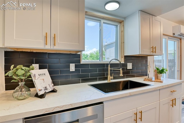 1228 Soaring Eagle Dr, Colorado Springs, CO 80915 - kitchen featuring a sink, a wall mounted air conditioner, and white cabinetry