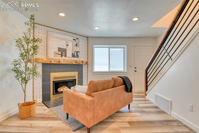 1228 Soaring Eagle Dr, Colorado Springs, CO 80915 - living area with baseboards, a fireplace, stairs, wood finished floors, and recessed lighting