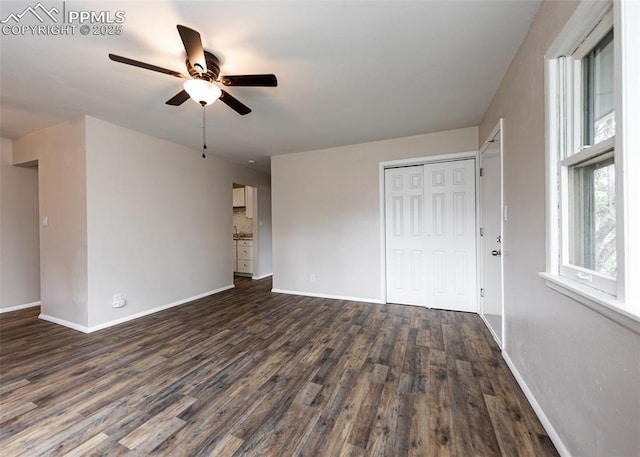 909 E Costilla St, Colorado Springs, CO 80903 - unfurnished living room featuring ceiling fan, baseboards, and dark wood-type flooring