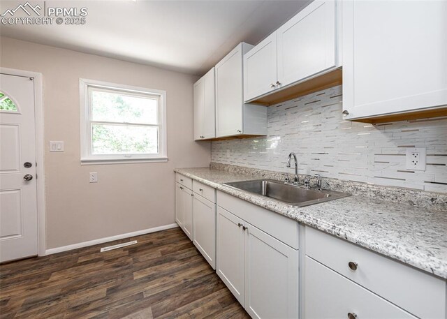 909 E Costilla St, Colorado Springs, CO 80903 - kitchen featuring a sink, backsplash, plenty of natural light, and baseboards