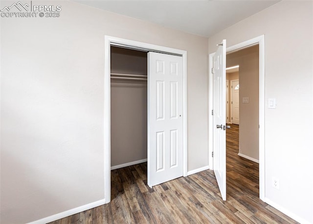 909 E Costilla St, Colorado Springs, CO 80903 - unfurnished bedroom with wood finished floors, a closet, and baseboards
