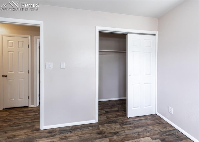 909 E Costilla St, Colorado Springs, CO 80903 - unfurnished bedroom featuring dark wood-type flooring, a closet, and baseboards
