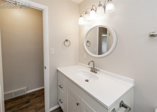 909 E Costilla St, Colorado Springs, CO 80903 - bathroom featuring vanity, wood finished floors, and baseboards