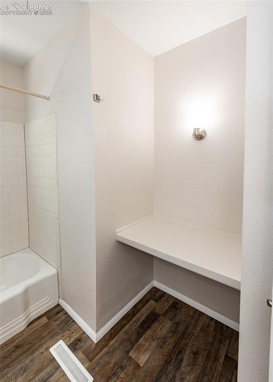 909 E Costilla St, Colorado Springs, CO 80903 - bathroom with wood finished floors, baseboards, and tub / shower combination