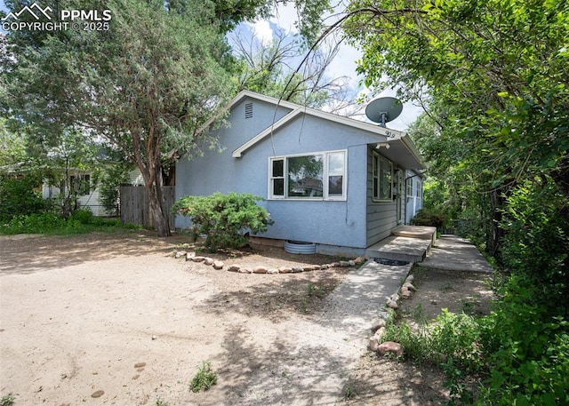 909 E Costilla St, Colorado Springs, CO 80903 - view of front of property with stucco siding and fence