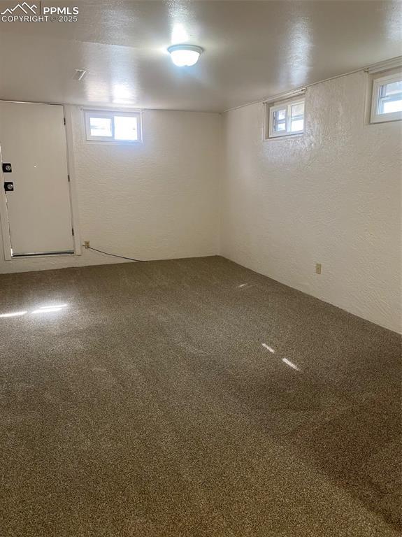 909 E Costilla St, Colorado Springs, CO 80903 - basement featuring carpet and a textured wall
