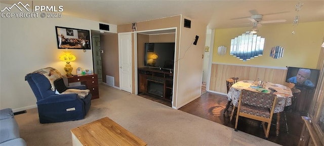 2510 N Union Blvd, Colorado Springs, CO 80909 - living area with ceiling fan, a wainscoted wall, a fireplace, baseboards, and carpet flooring