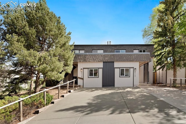 2115 Friendship Cir, Colorado Springs, CO 80904 - view of front of home with mansard roof, roof with shingles, fence, and an outdoor structure
