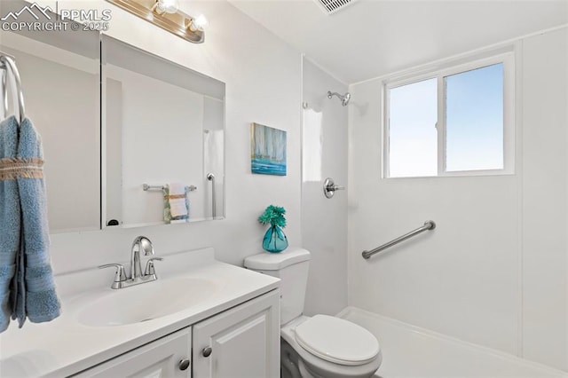 2115 Friendship Cir, Colorado Springs, CO 80904 - bathroom with toilet, vanity, and a shower