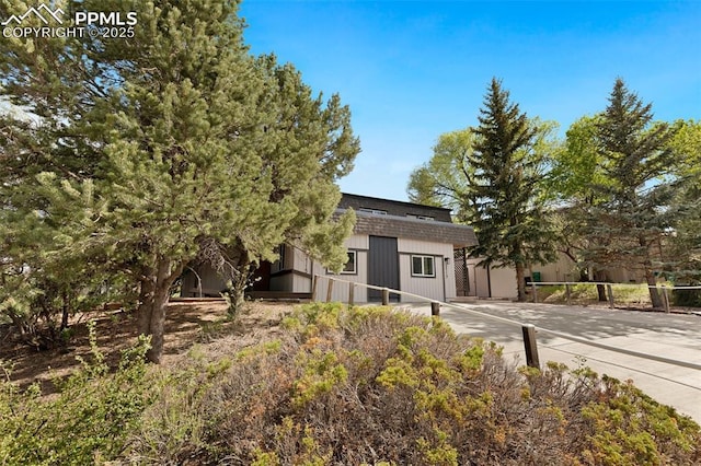 2115 Friendship Cir, Colorado Springs, CO 80904 - view of front of home with a shingled roof, concrete driveway, and mansard roof
