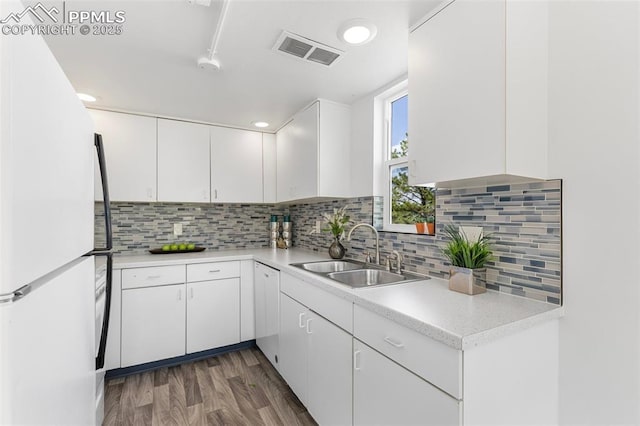 2115 Friendship Cir, Colorado Springs, CO 80904 - kitchen with a sink, freestanding refrigerator, white cabinetry, and light countertops
