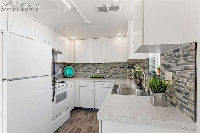 2115 Friendship Cir, Colorado Springs, CO 80904 - kitchen with white appliances, a sink, dark wood-style flooring, decorative backsplash, and white cabinets
