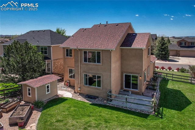 2044 Coldstone Way, Colorado Springs, CO 80921 - back of house with stucco siding, an outbuilding, a garden, and roof with shingles