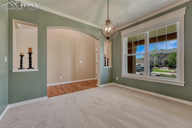 2044 Coldstone Way, Colorado Springs, CO 80921 - carpeted empty room with crown molding, arched walkways, baseboards, and a chandelier