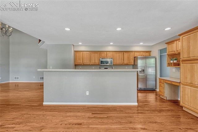 9524 Pinebrook Way, Colorado Springs, CO 80920 - kitchen with appliances with stainless steel finishes, light wood finished floors, light countertops, recessed lighting, and a center island with sink