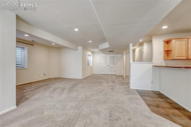 9524 Pinebrook Way, Colorado Springs, CO 80920 - unfurnished living room featuring recessed lighting, a textured ceiling, light colored carpet, and baseboards
